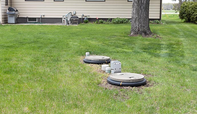 Residential septic tank access points installed in a yard