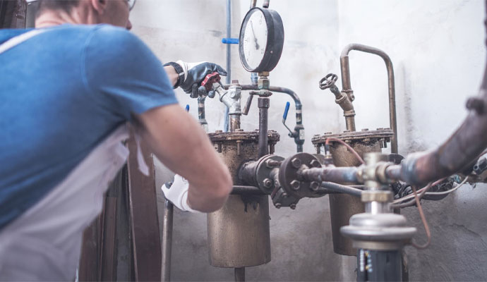 Technician Fixing Pipeline