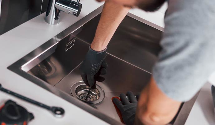 Expert cleaning sink drain using tools