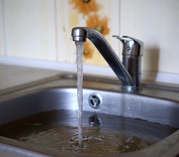 Kitchen sink with running faucet