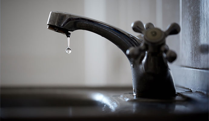 Metal faucet with water droplet