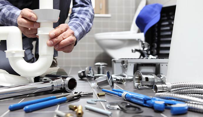 Plumber working under bathroom sink