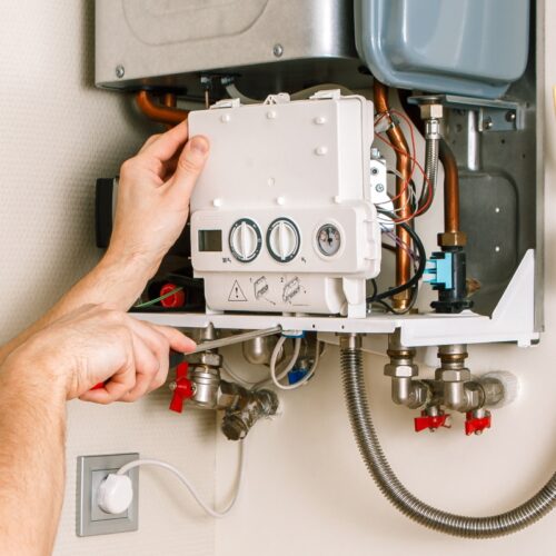 Plumber attaches Trying To Fix the Problem with the Residential Heating Equipment gastonia nc